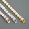 Flat-laid 5mm tennis chains in three colors showing one clasp