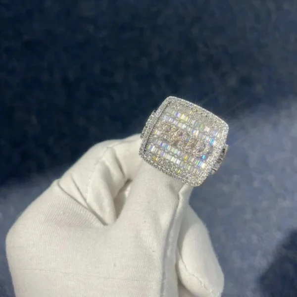Hip Hop Champion Ring in sterling silver with moissanite, 14K white gold plated, iced out top with baguette stones and round stones forming "Paid", side details with raised 72