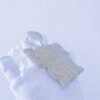 Left angled view of custom large letter name pendant in 925 silver with VVS moissanite, plated in 18K white gold, held in hand.