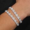 man wearing 8mm moissanite heart bracelet in 14K gold