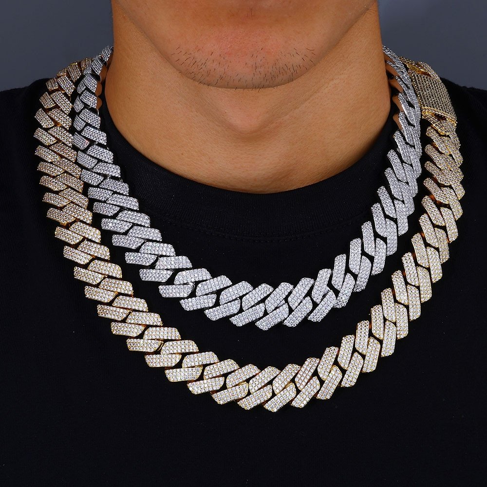 Man wearing two bold Cuban chains in gold and silver iced out with CZ stones