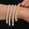 Woman wearing 5mm VVS moissanite tennis bracelet in 14K gold plating, available in white gold, yellow gold, and rose gold colors