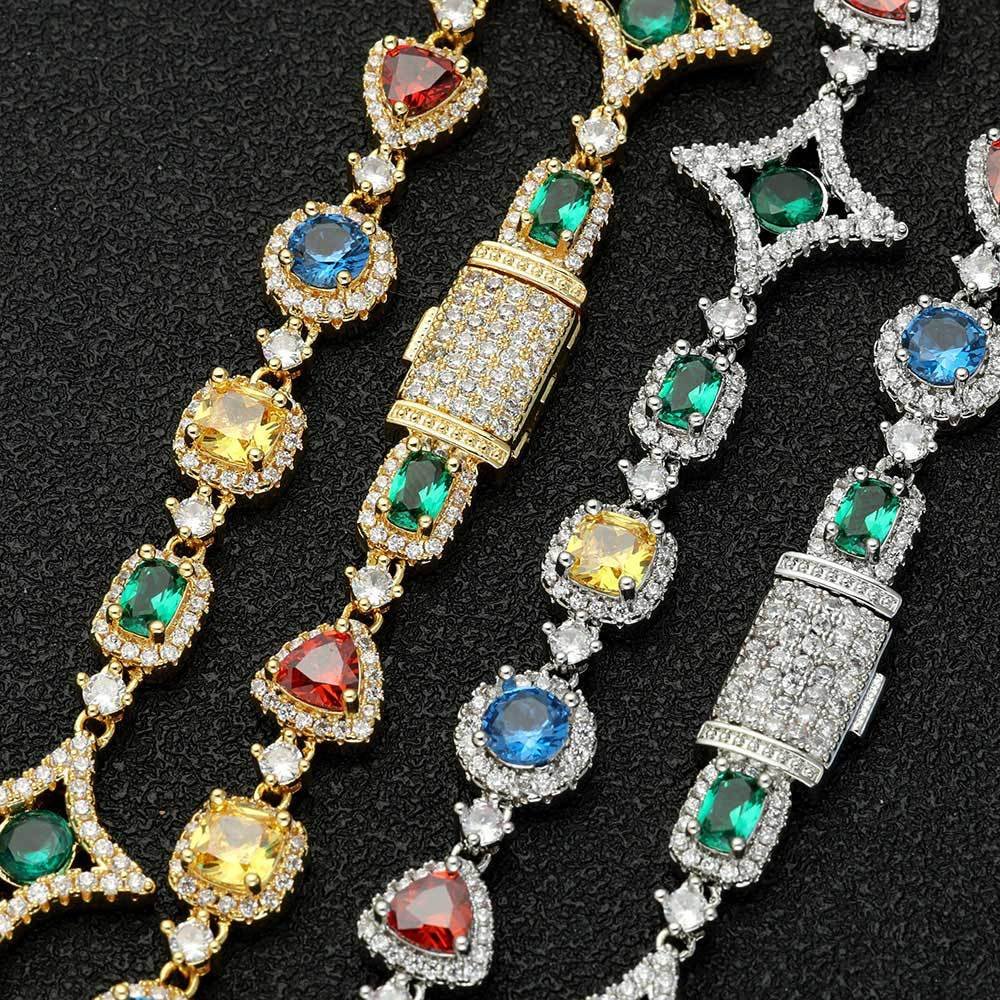 Four tennis chains in silver and gold laid flat on a table with clasps closed