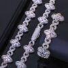 Silver Lucky Clover Cuban Link set (necklace & bracelet) on table, bracelet flat, necklace clasp closed.