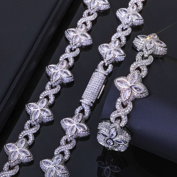 Silver Lucky Clover Cuban Link set (necklace & bracelet) on table, bracelet flat, necklace clasp closed.