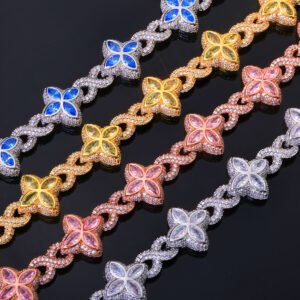 Four Colorful Lucky Clover Iced Cuban Link chains flat on black background – silver, gold, rose gold, and silver with blue CZ clovers.