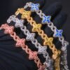 Four Lucky Clover Cuban Link chains in various colors displayed in hand.