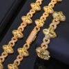 Gold Lucky Clover Cuban Link set (necklace & bracelet) on table, bracelet flat, necklace clasp closed.