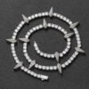 Silver panther tennis chain coiled on a black background showing iced out shine
