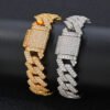 One gold and one silver 14mm brass Cuban bracelet wrapped around a cylinder for wear simulation