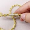 Close-up of gold iced moissanite lock on 6mm rope chain
