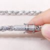 Close-up of white gold iced moissanite lock on 6mm rope chain