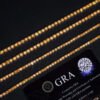 Close-up of yellow VVS moissanite stones on 14K white gold plated tennis chain