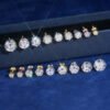 Close-up of multi-size six-prong solitaire stud earrings
