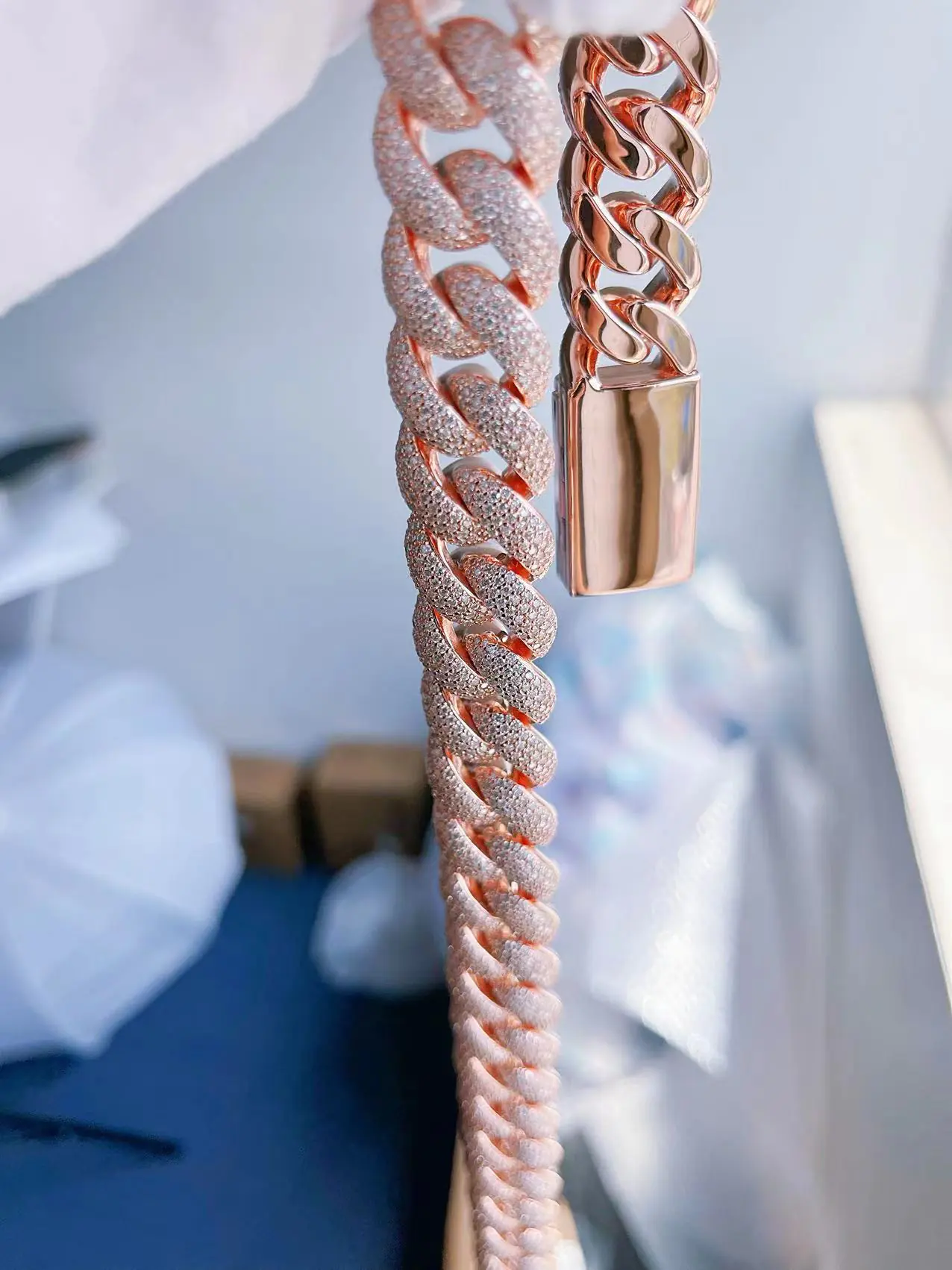 17mm custom Cuban link chain in silver with VVS moissanite, shown hanging by hand to display both front and back details