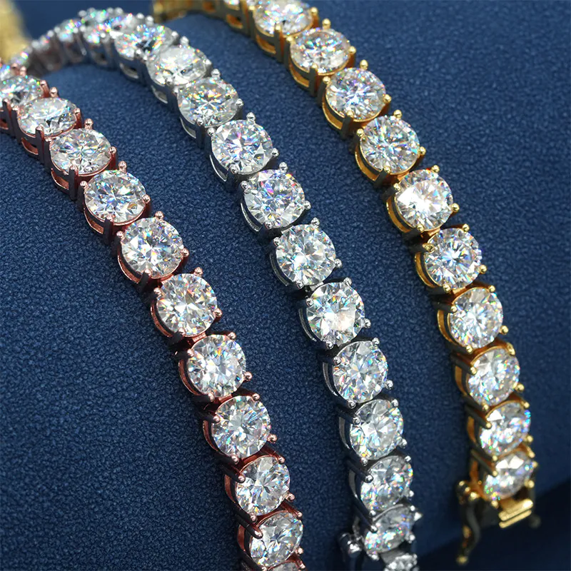 Three 5mm moissanite tennis chains in white gold, yellow gold, and rose gold wrapped on a cylinder showing stone clarity
