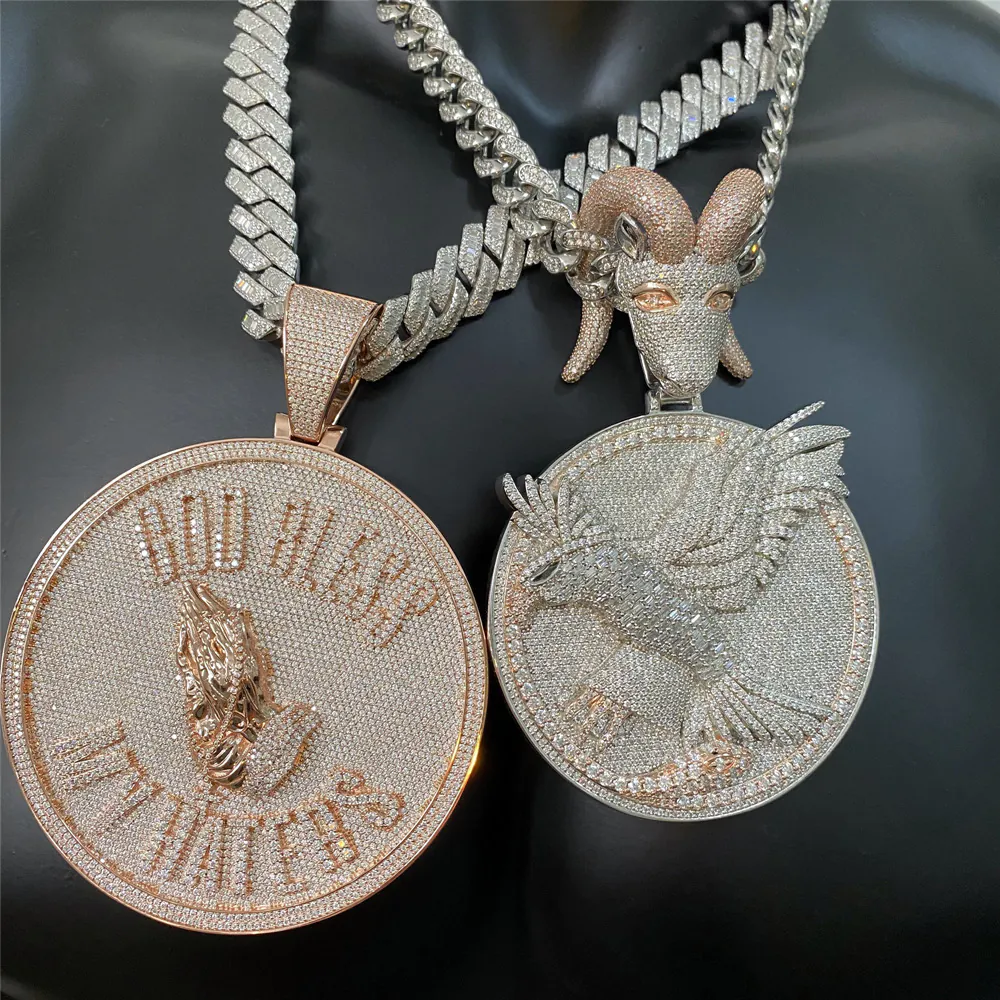 Custom round disc pendant with semi-relief eagle and goat head bail, paired with 18mm fully iced Cuban link chain, worn on mannequin alongside another Cuban chain pendant.