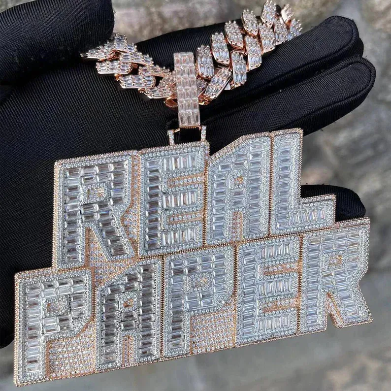 Large custom letter pendant with sparkling moissanite stones on thick Cuban chain, viewed from front angle.