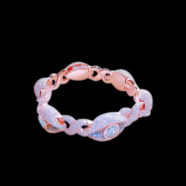 Infinity Eyes Cuban Chain bracelet in sterling silver with VVS moissanite, rose gold plated, 8mm wide with blue and 0.5ct white stones on black background