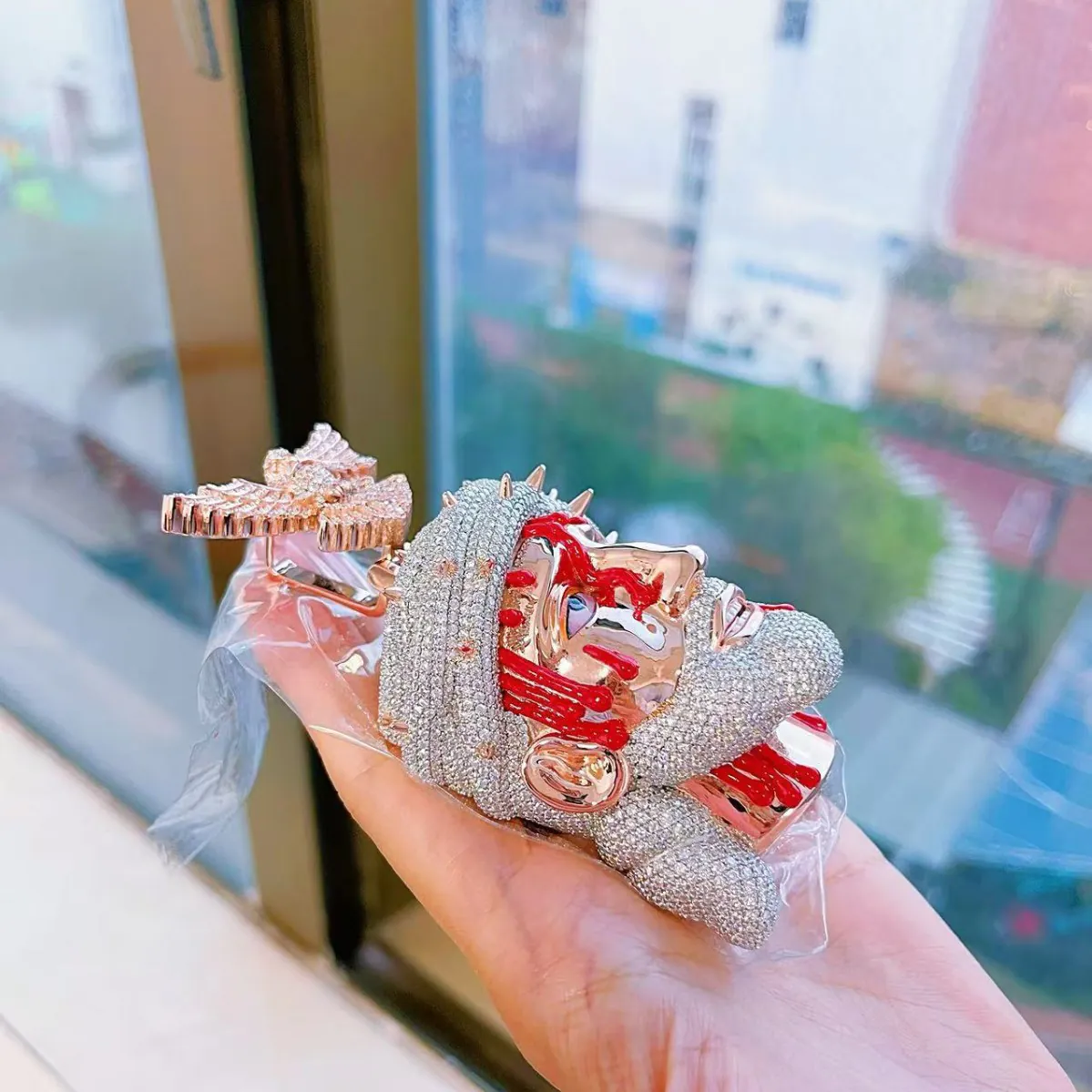 Side view of custom large Jesus pendant in 925 silver with VVS moissanite, face plated in 14K rose gold, crown and beard in 14K white gold, red enamel blood details, highlighting 3D relief design.