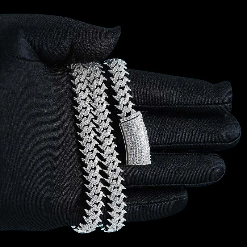 Close up of 10MM Spiked Moissanite Cuban Link Chain in sterling silver with VVS moissanite, 14K white gold plated, box clasp detail wrapped around hand