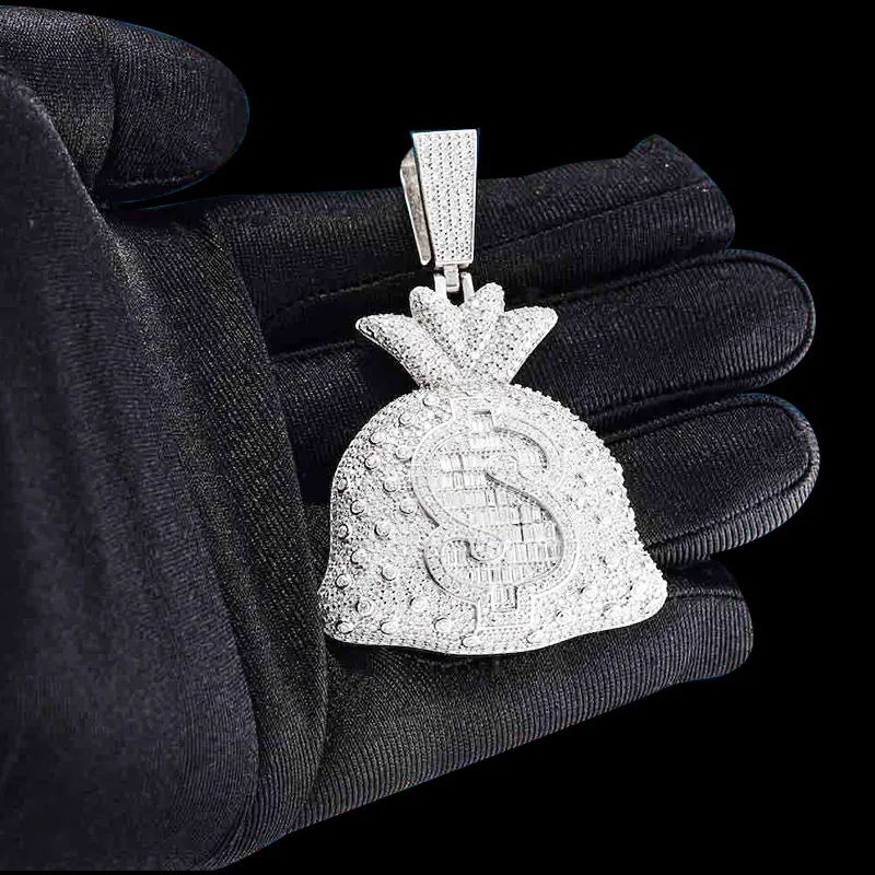 Close up of Moneybag Pendant in brass with CZ stones, 14K white gold plated, iced out pendant held in hand, front view