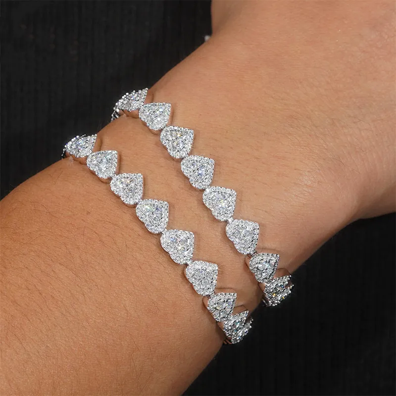 man wearing 8mm moissanite heart bracelet in 14K gold