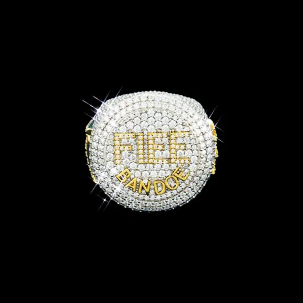 FIEE BANDOE Ring in sterling silver with moissanite, white gold plated, iced out circular top with FIEE letters in gold set with round white stones and BANDOE letters below