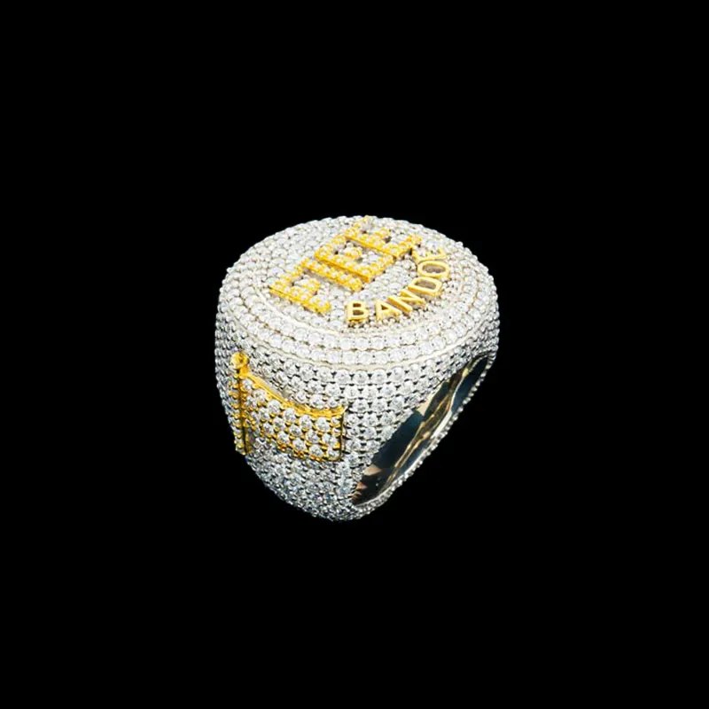 Side view of FIEE BANDOE Ring in sterling silver with moissanite, white gold plated, iced out hip hop ring showcasing circular top and raised gold letters