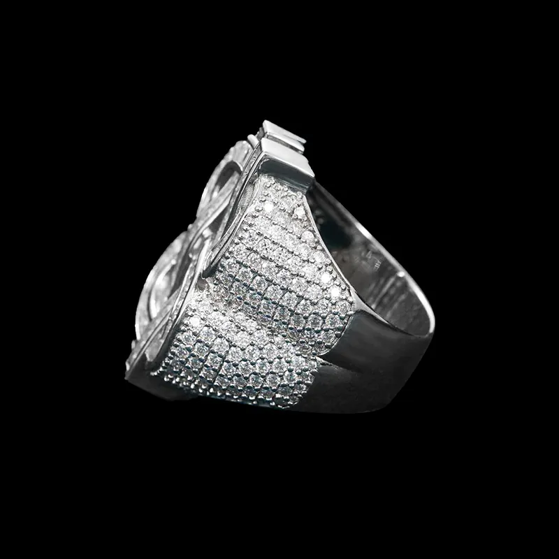 Side view of Dollar Sign CZ Ring in brass with baguette and round CZ stones, 14K white gold plated, iced out hip hop jewelry showcasing side detailing