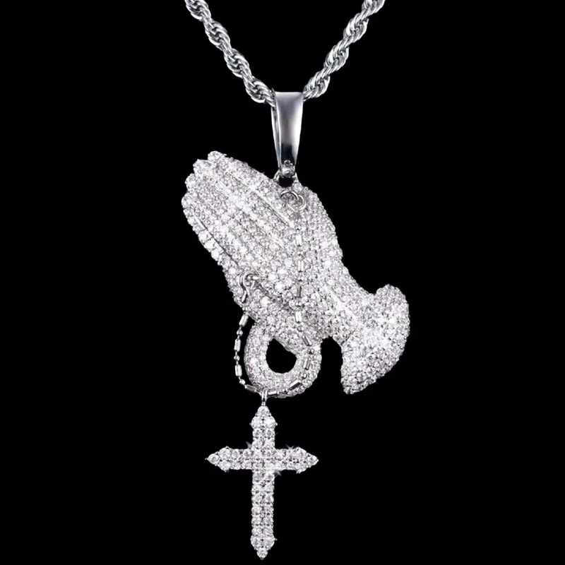 VVS Praying Hands Pendant in brass with CZ stones, 14K white gold plated, hanging on 3mm rope chain on black background, iced out hip hop jewelry