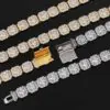 Four cluster tennis chains in gold and silver laid flat on table with open clasps