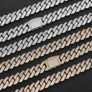 Six iced out 10mm Miami Cuban chains in silver and gold laid on black background