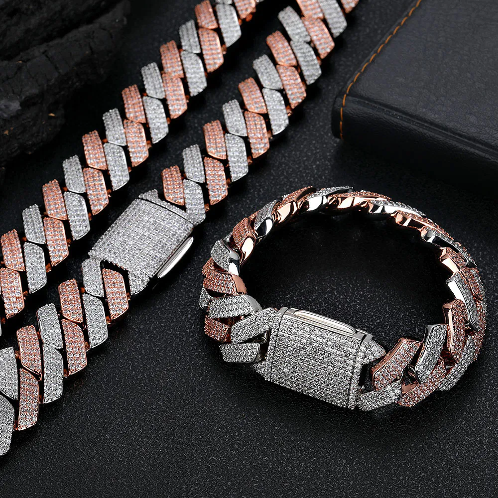 Two-tone rose gold and silver bold Cuban chain set on table, necklace laid flat, bracelet closed and standing