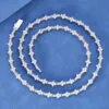 Silver iced Special Links Tennis Chain coiled neatly on blue background for close-up view