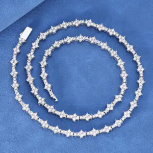 Silver iced Special Links Tennis Chain coiled neatly on blue background for close-up view