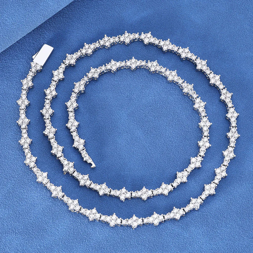 Silver iced Special Links Tennis Chain coiled neatly on blue background for close-up view