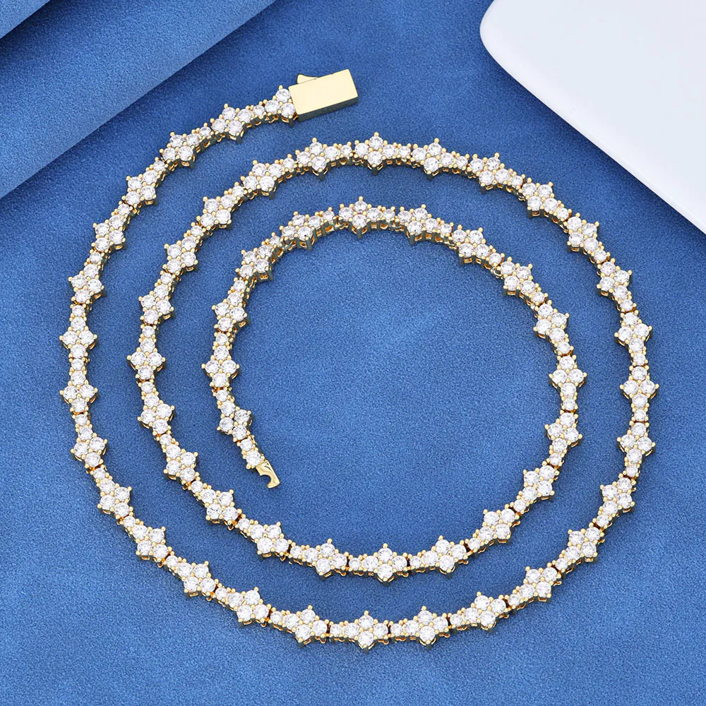 Gold iced Special Links Tennis Chain coiled neatly on blue background for close-up view