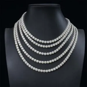 Five 6.5mm 925 silver moissanite tennis chains hanging on mannequin display