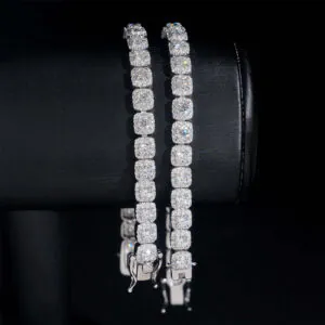 Two 6mm white gold moissanite tennis bracelets hanging on cylinder showing fire and clarity