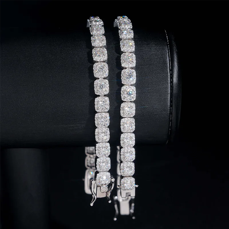 Two 6mm white gold moissanite tennis bracelets hanging on cylinder showing fire and clarity