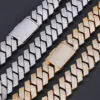 Two silver and two gold 26mm iced Cuban link chains laid flat on a black background, showcasing bold 4-row CZ stones.