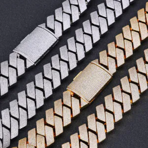 Two silver and two gold 26mm iced Cuban link chains laid flat on a black background, showcasing bold 4-row CZ stones.