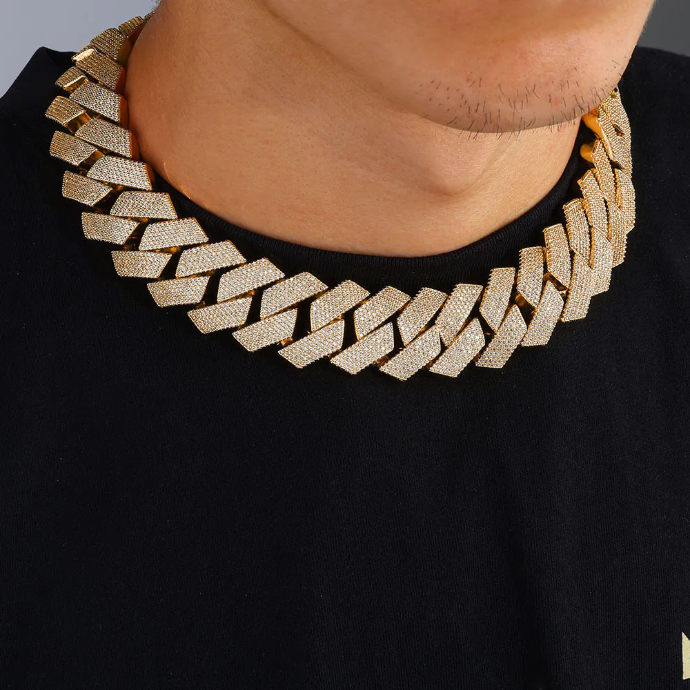 Man wearing a gold 26mm oversized Cuban chain, demonstrating bold hip hop style and statement fashion