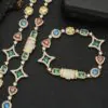 Gold colored tennis chain and bracelet set laid flat on a table with clasp closed