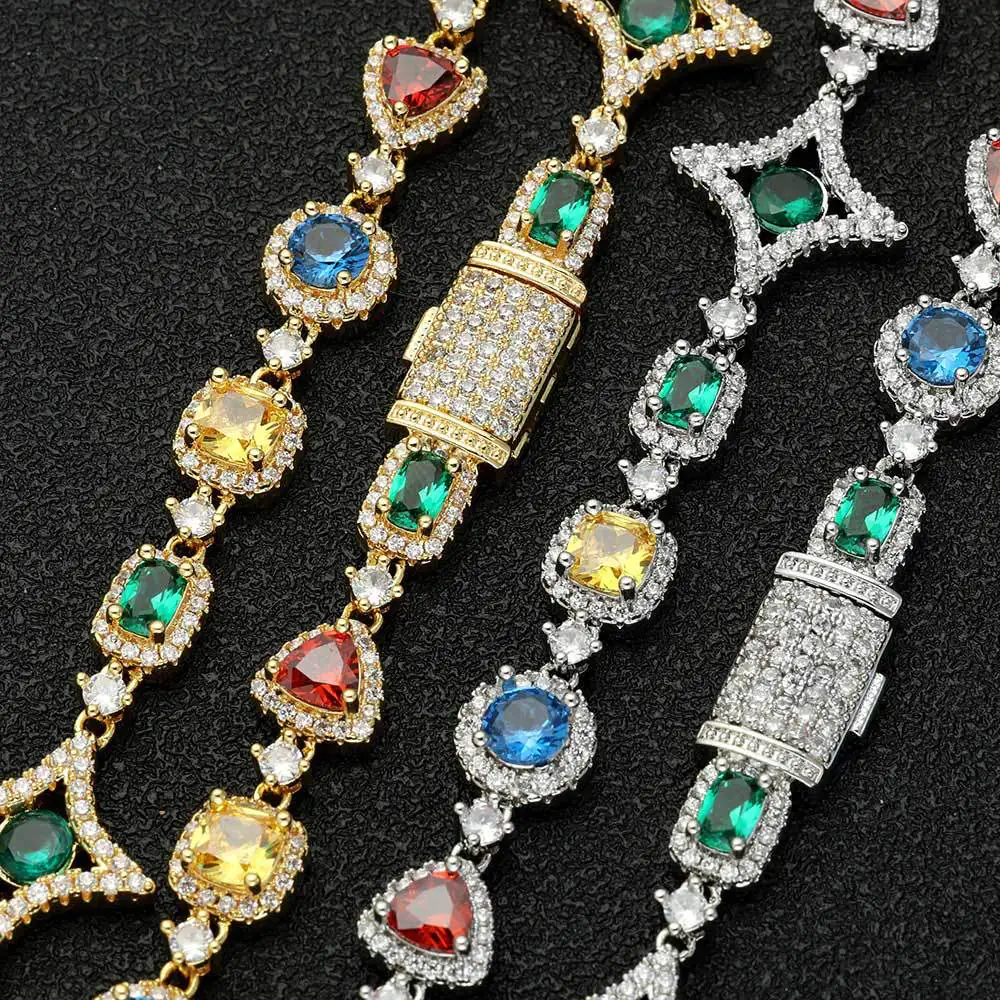 Four tennis chains in silver and gold laid flat on a table with clasps closed