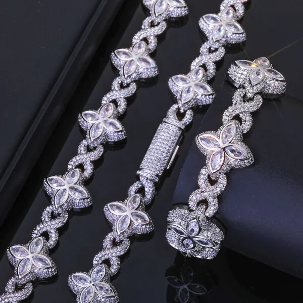 Silver Lucky Clover Cuban Link set (necklace & bracelet) on table, bracelet flat, necklace clasp closed.