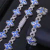Silver Lucky Clover Cuban Link with blue CZ clovers on table,   bracelet flat,   necklace clasp closed.