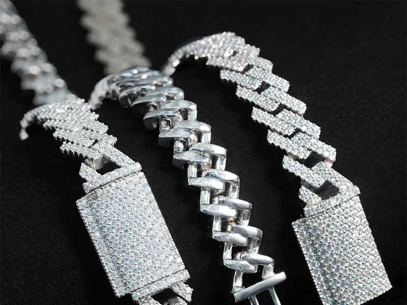 Close-up of custom clasps and backside details on 10mm moissanite Cuban chains in three colors