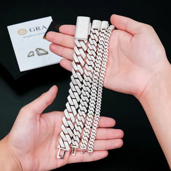 Hand holding multiple sizes of rhombus-shaped 925 silver moissanite Cuban link chains for comparison